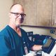 Smiling doctor working on a medical equipment.